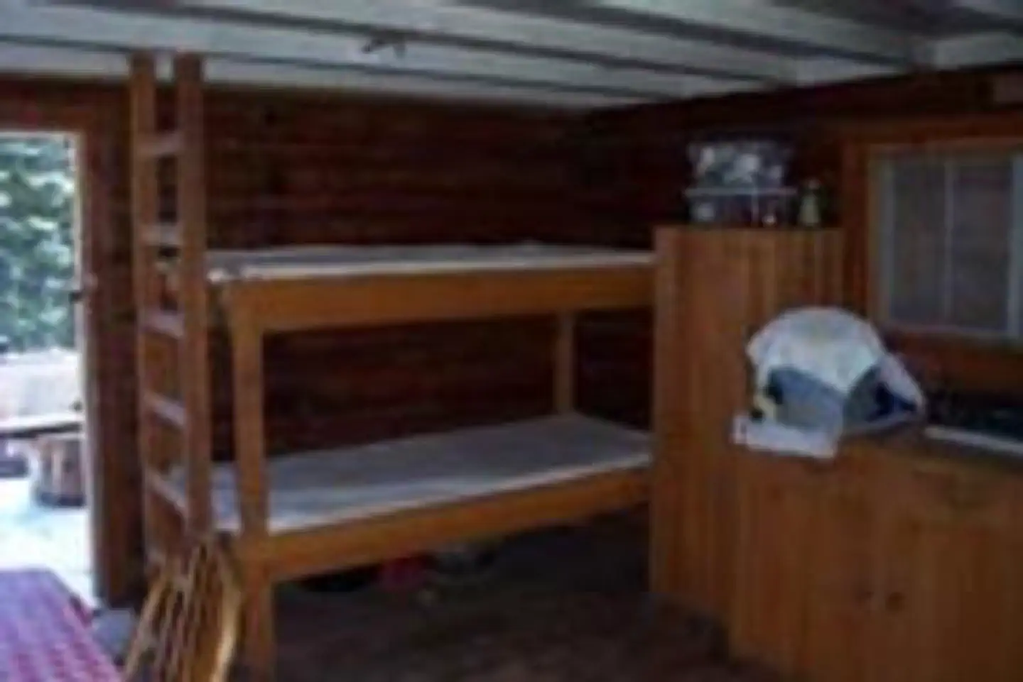 Indian Flats Cabin — Inside view of the cabin with bunkbed and cabinet storage