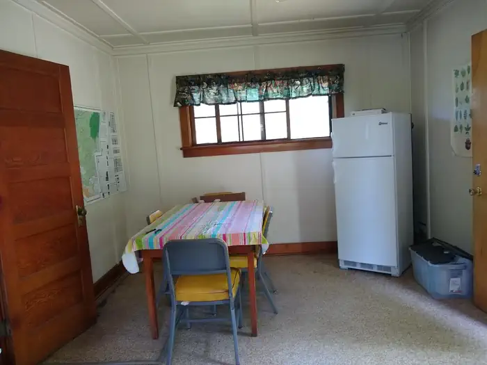 Deer Park Cabin β A refrigerator next to a window and dining room table.