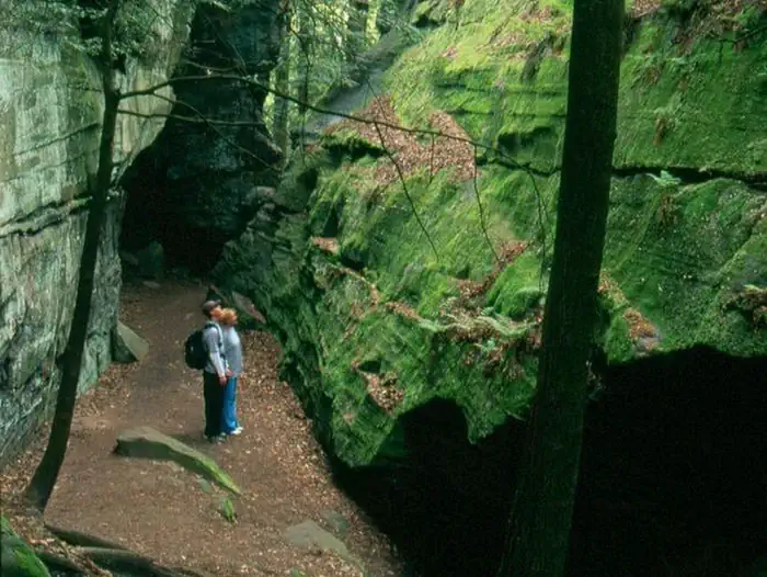 Cuyahoga Valley National Park - CAMPING NO LONGER OFFERED — Hikers look at the high rock walls at the Ledges