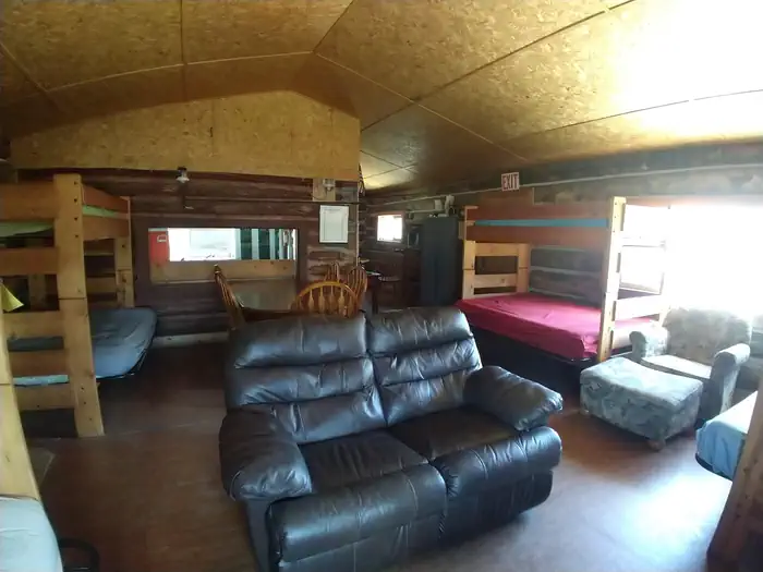 Stone Cellar Guard Station β Living quarters, with leather loveseat, fabric chair with ottoman, 4 sets of bunkbeds (bottom is full size, top is single)