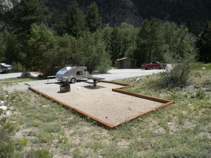 Chalk Lake — Campsite with small camp trailer with trees in background