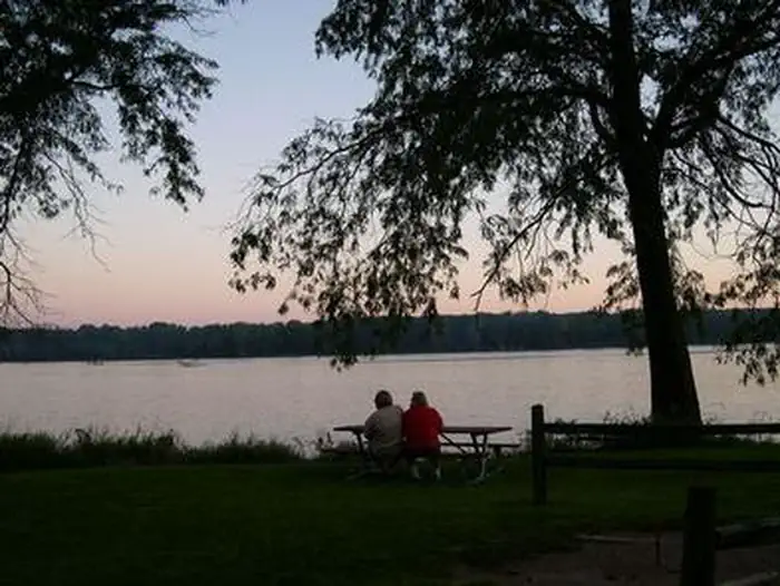 Clarks Ferry — People at a picnic table at sunset overlooking the river.