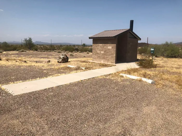 Painted Rock Petroglyph Campground — West single vault toilet with parking and cement walkway
