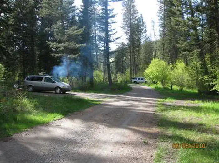 PINE CREEK CAMPGROUND — Pine Creek Campground road, pine trees, vehicles
