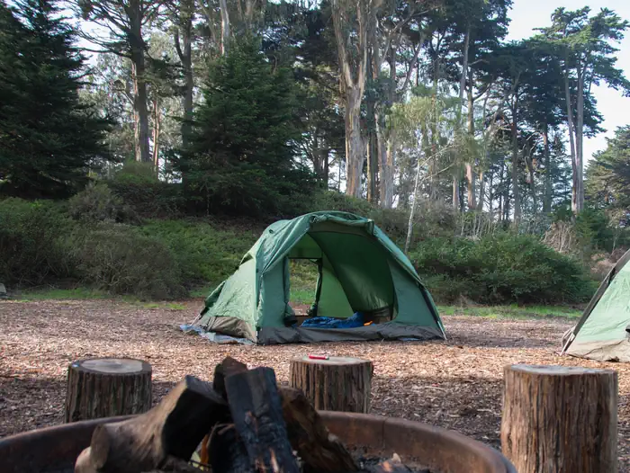 Rob Hill Group Campground — One green tent with trees in the background