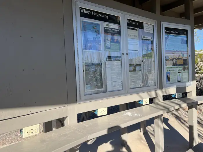 TWIN PEAKS CAMPGROUND — Information boards and wall plugs at the ramada.