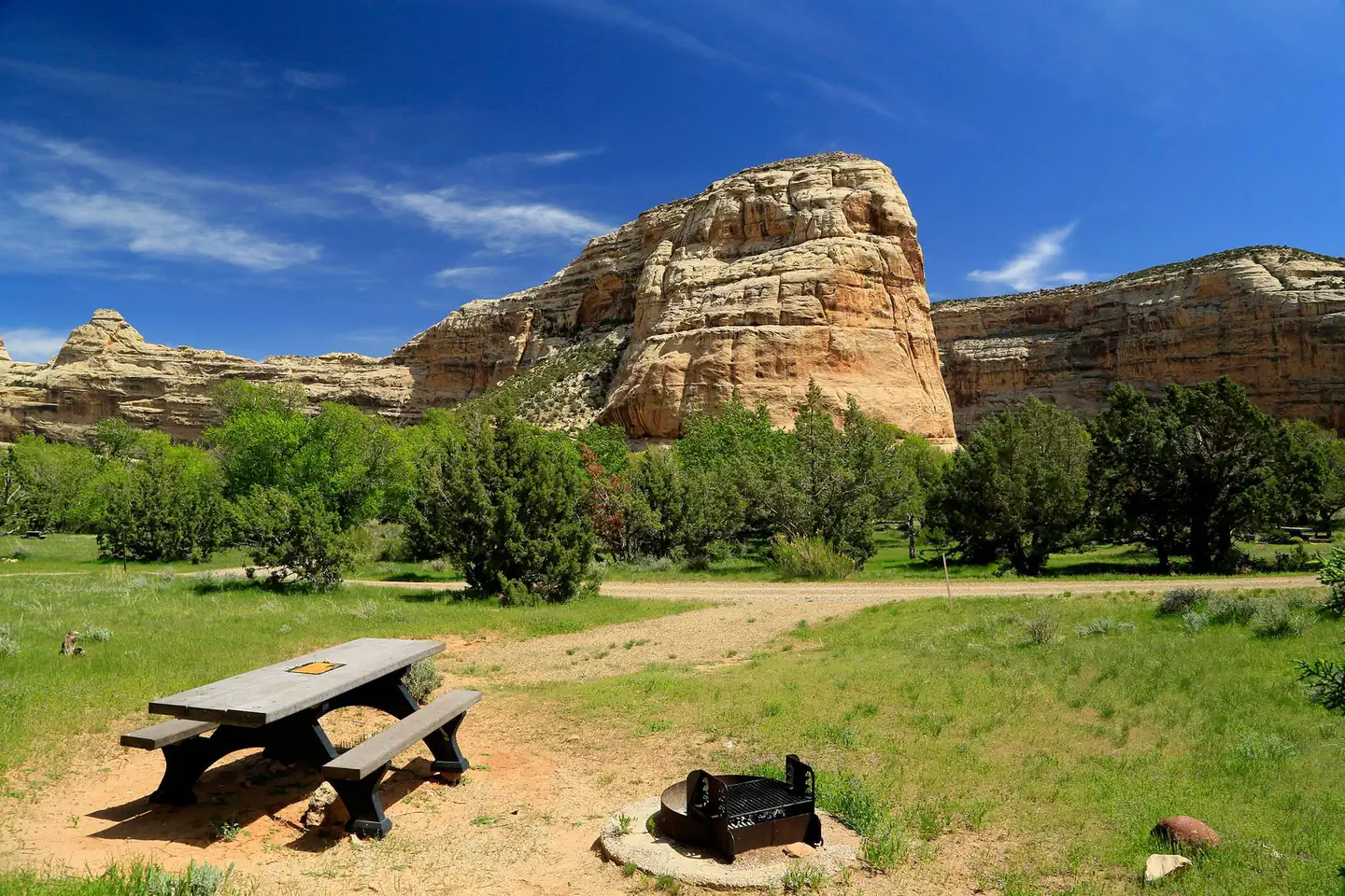 Echo Park Campground — A picnic table at a campsite in Echo Park Campground with Rock Formations in the background