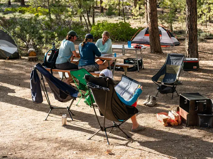 Sunset Campground (UT) — Tent campers relax at a picnic table at Sunset Campground