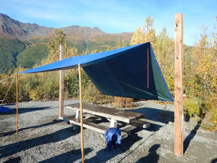 Spencer Glacier Whistle Stop Group Campground — Central camp area with tarp hung from tarp poles.