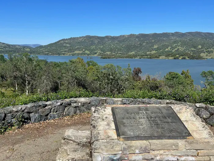 CHEKAKA RECREATION AREA LAKE MENDOCINO — Coyote Dam & Lake Mendocino plaque mounted to stone wall, with view of Lake Mendocino in the background