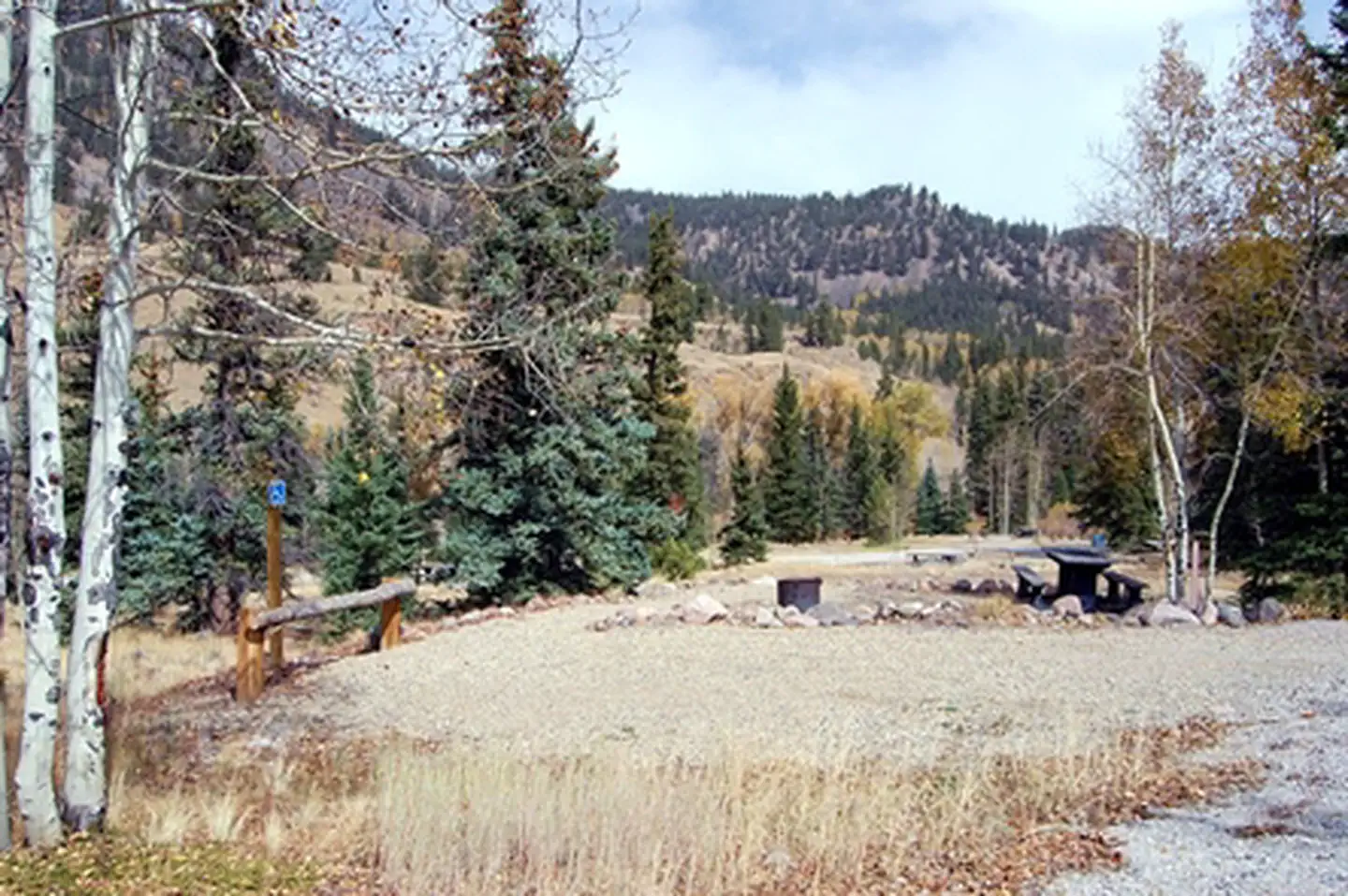 Mill Creek Campground (CO) — Typical campsite at Mill Creek with gravel parking area, picnic table, and fire ring.