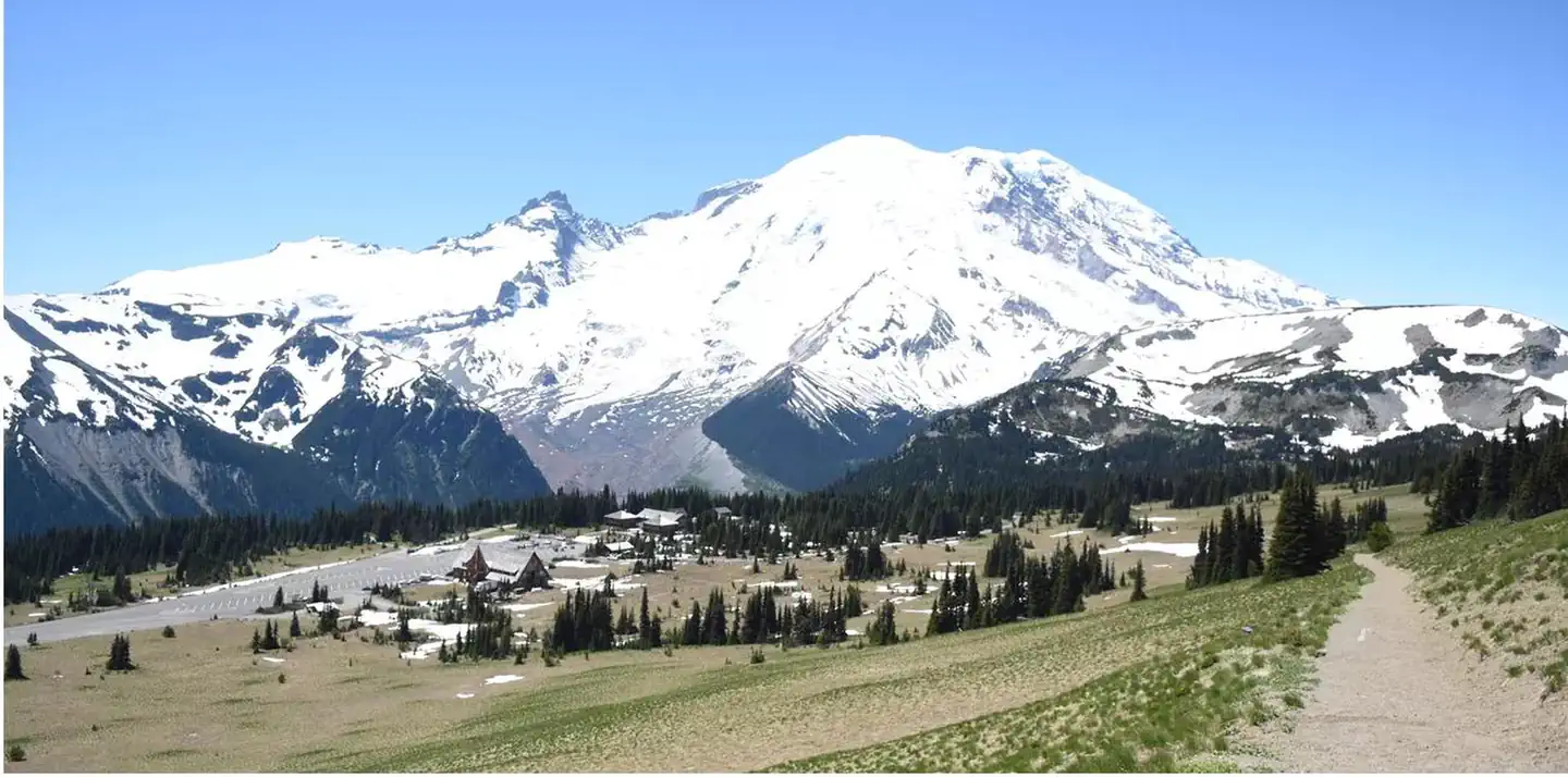 White River Campground — A panoramic view hiking on trail above the subalpine meadows of Sunrise with Mount Rainier in the background.