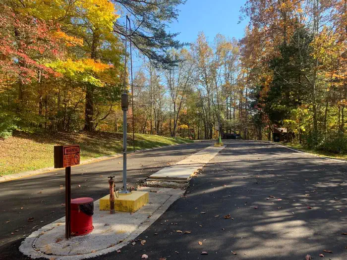 Wilderness Road Campground — A blacktop road with red and yellow cables to the left.