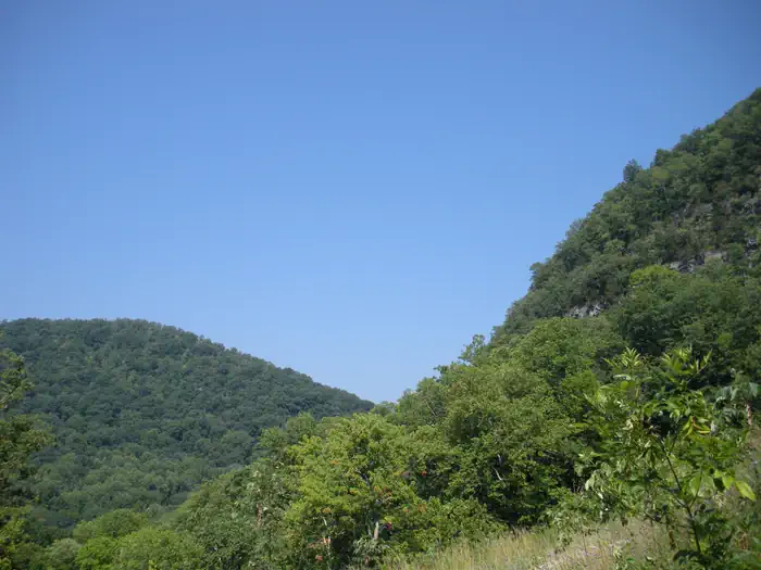Wilderness Road Campground — A light blue sky with green mountains.