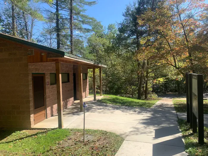 Wilderness Road Campground — A sidewalk with a brown building to the left.