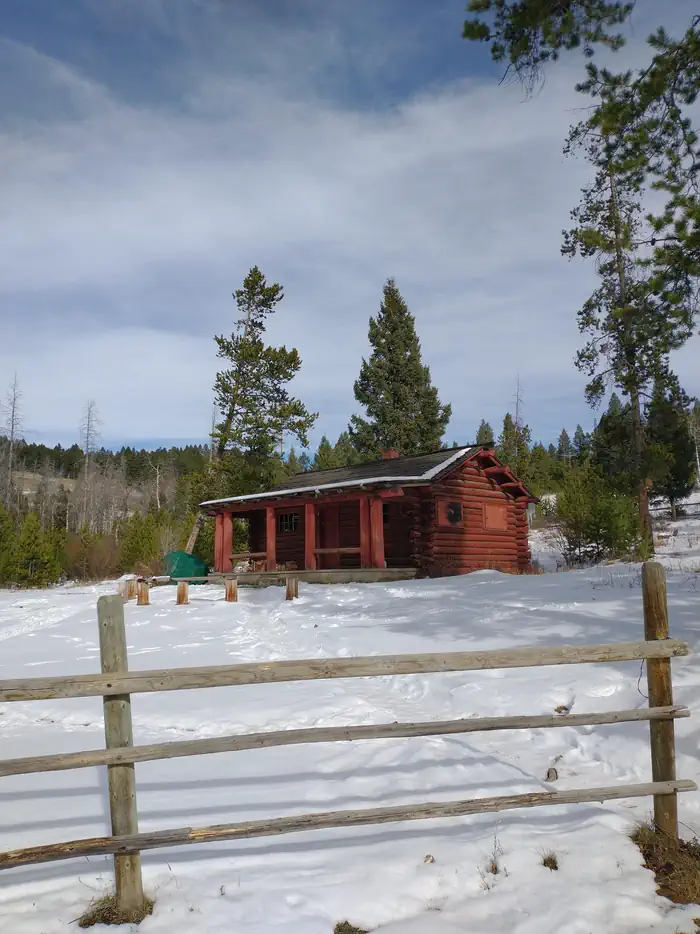 High Rye Cabin — High Rye Cabin, view from parking lot, Red Cabin with snow on the ground surrounded by green trees