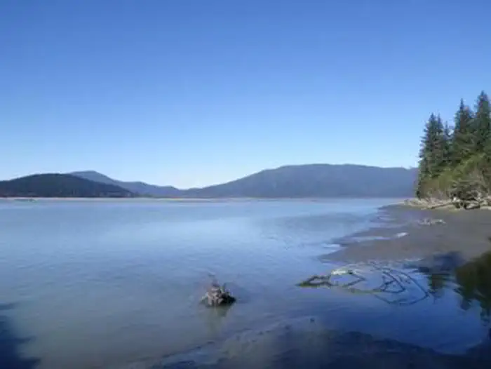 Garnet Ledge Cabin — Water with mountains in background and green trees on shoreline