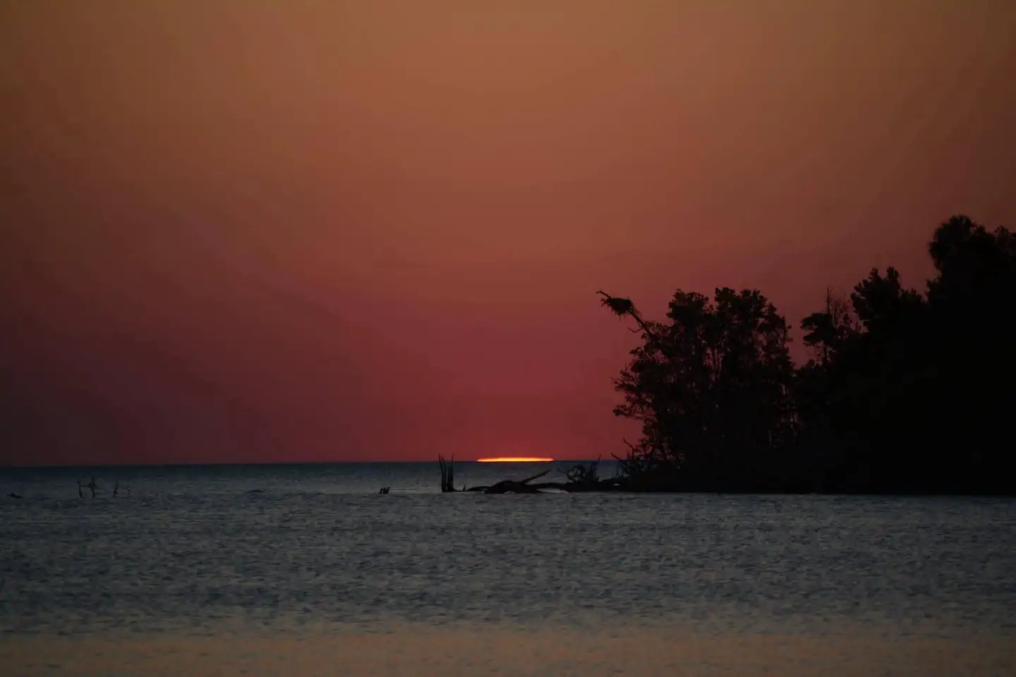 Everglades Backcountry Wilderness Camping Permits — The last light of the sunset is visible on the horizon over the water