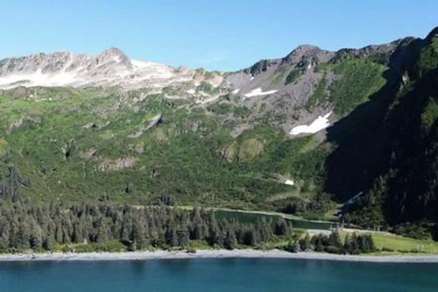 Kenai Fjords National Park Cabins — Glacier-carved peaks at Kenai Fjords National Park with the bay in the foreground