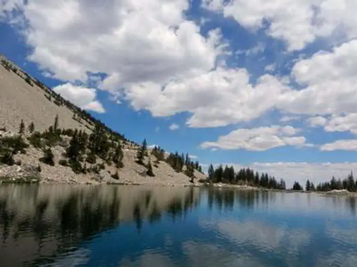 Grey Cliffs Campground — Mountain Lake with surface reflecting clouds and sky