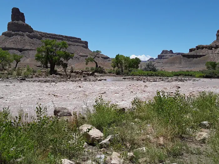 Swasey's Beach — A photo looking across a river rapid to low buttes on the other side