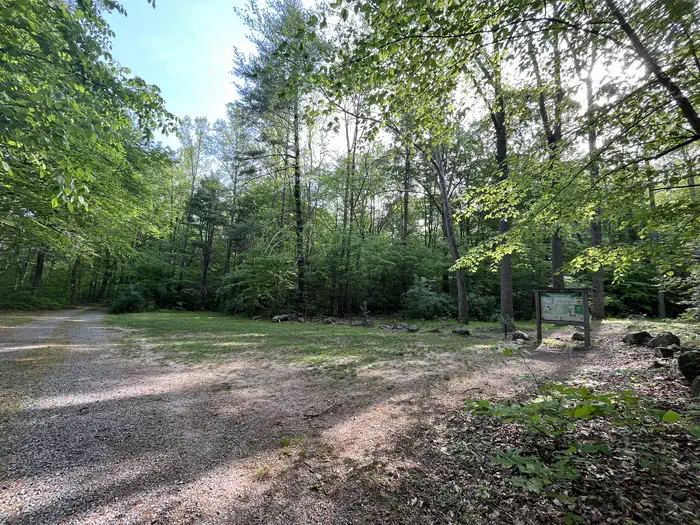 Hopper Creek Group Camp — A gravel drive opens to a grassy patch with large rocks bordering