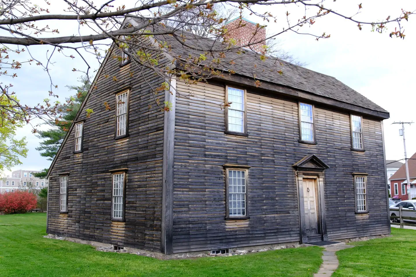 Adams National Historical Park — A New England "saltbox" style home with brown wood siding. 