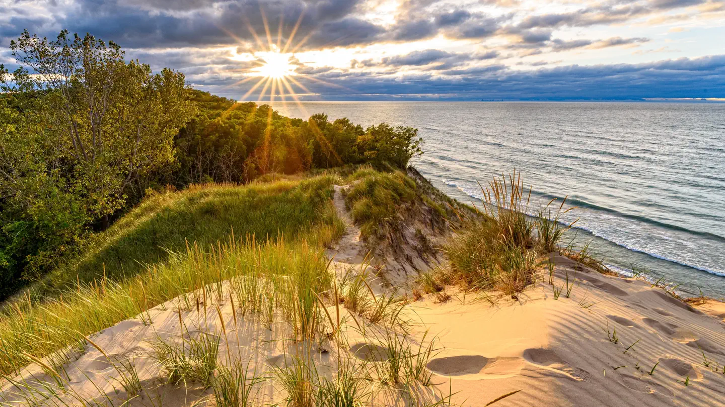 Indiana Dunes National Park — Looking west from the top of Mt. Baldy the sun sets over Lake Michigan.