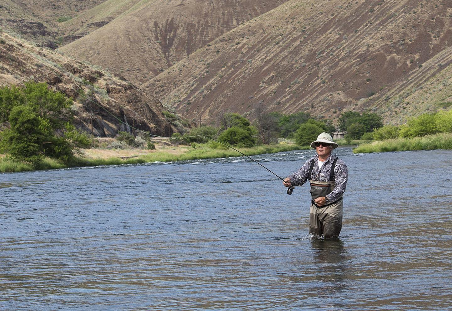 Lower Deschutes River Back Country Byway — A fly fisherman tries his luck on the Deschutes river.