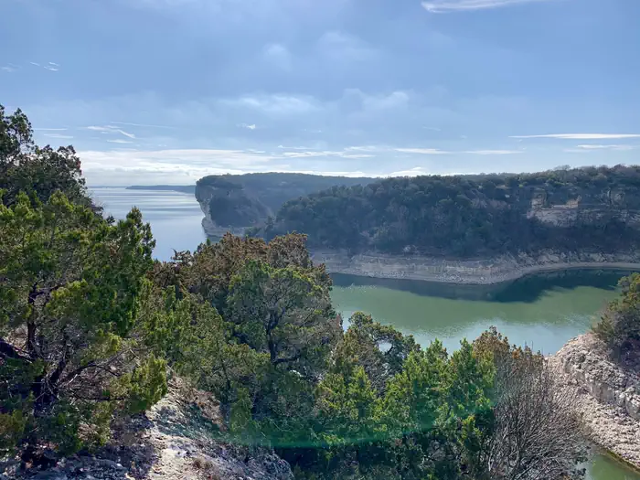 Whitney Lake — Limestone bluffs covered with ashe juniper trees surrounding Whitney Lake.