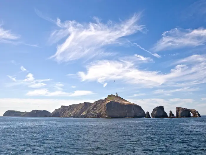 Channel Islands National Park — Small island with arch rock and lighthouse on top.