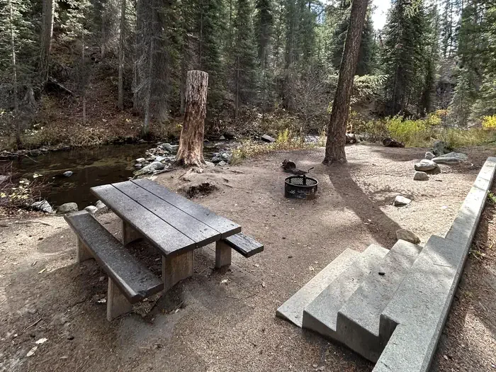 Ten Mile Campground: Stairs lead to creekside campsite with picnic table and fire ring.