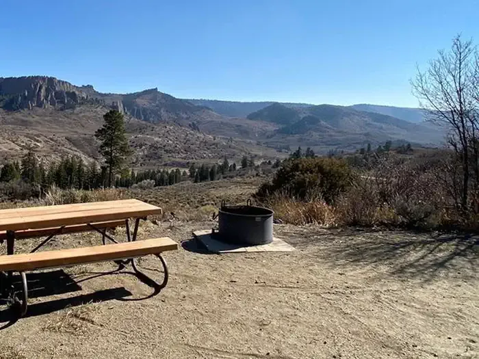 Ponderosa - Curecanti National Recreation Area: An amazing view from Ponderosa Campground showing a picnic table and firepit in the foreground