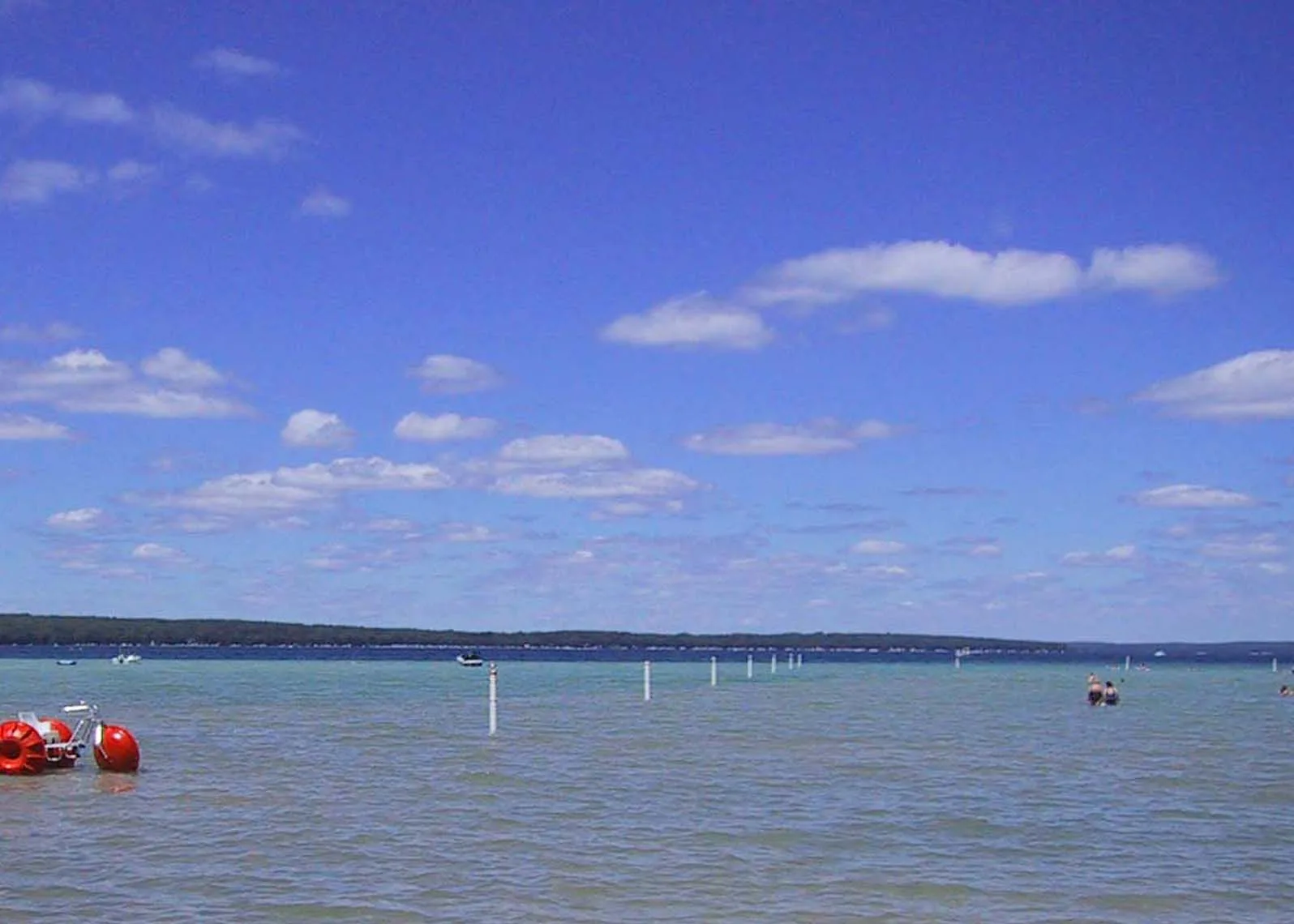 Buoyed swim area on Higgins Lake under a blue sky