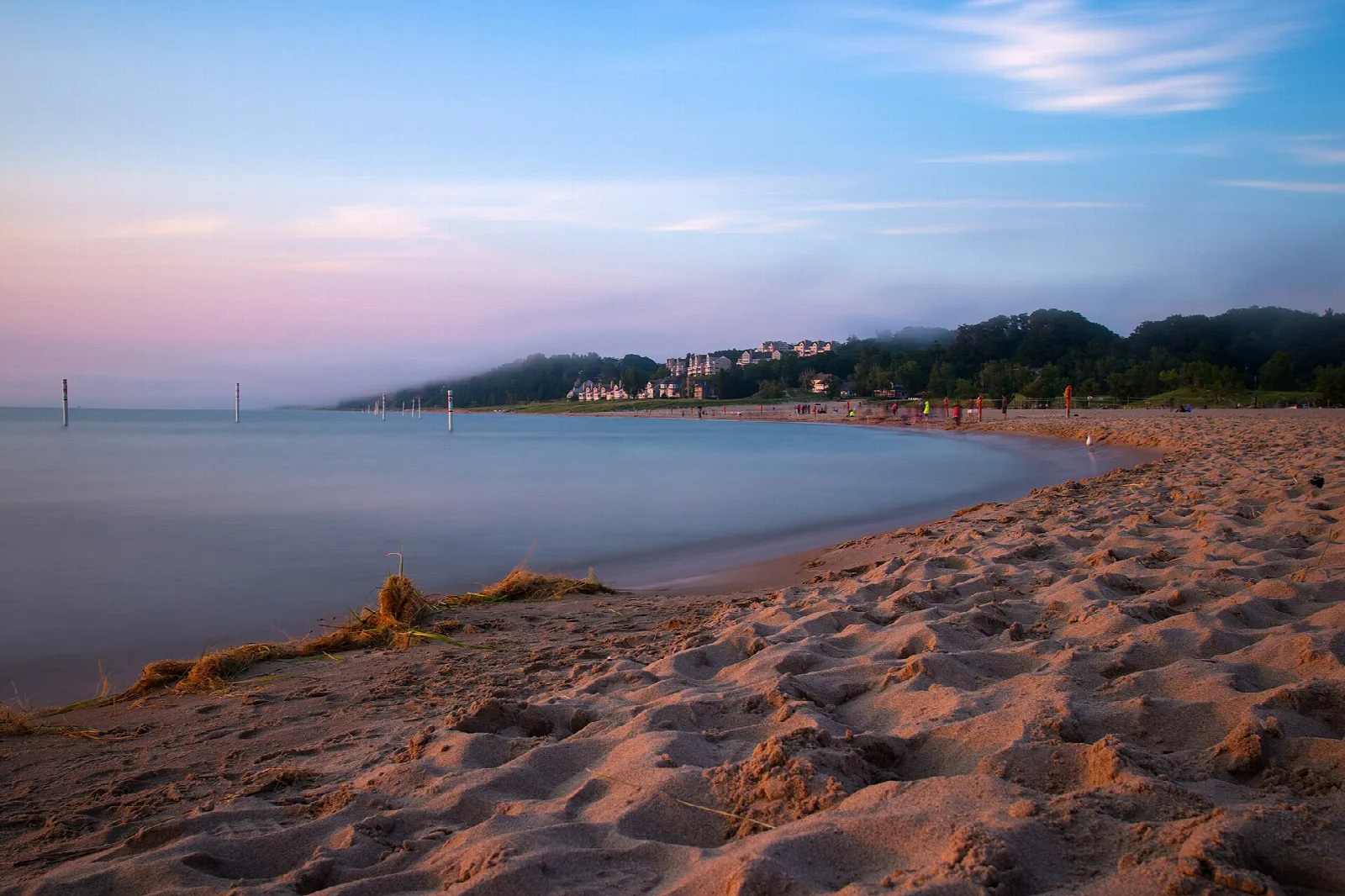 Lake Michigan shore at dusk with sand in the foreground