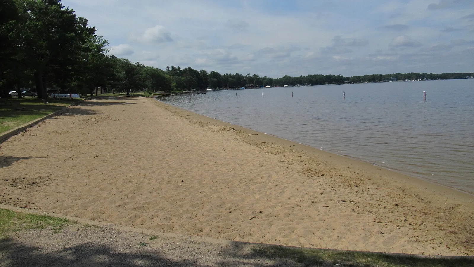 Sandy beach curving along a lake shore