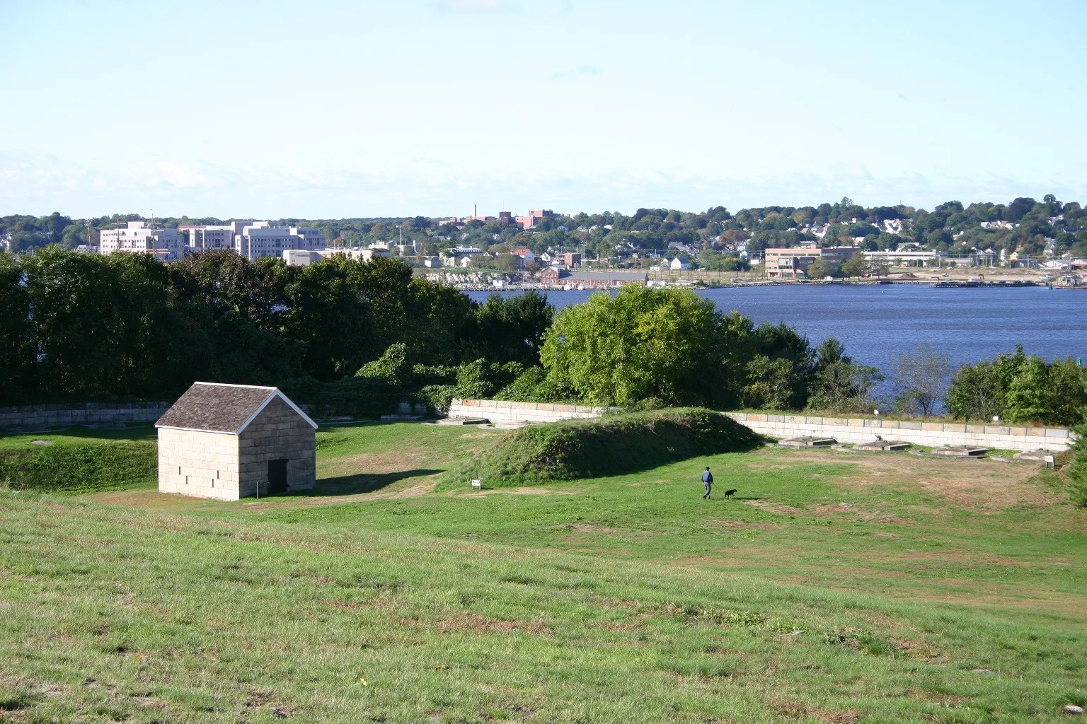 Stone building on a grassy fort wall above the river
