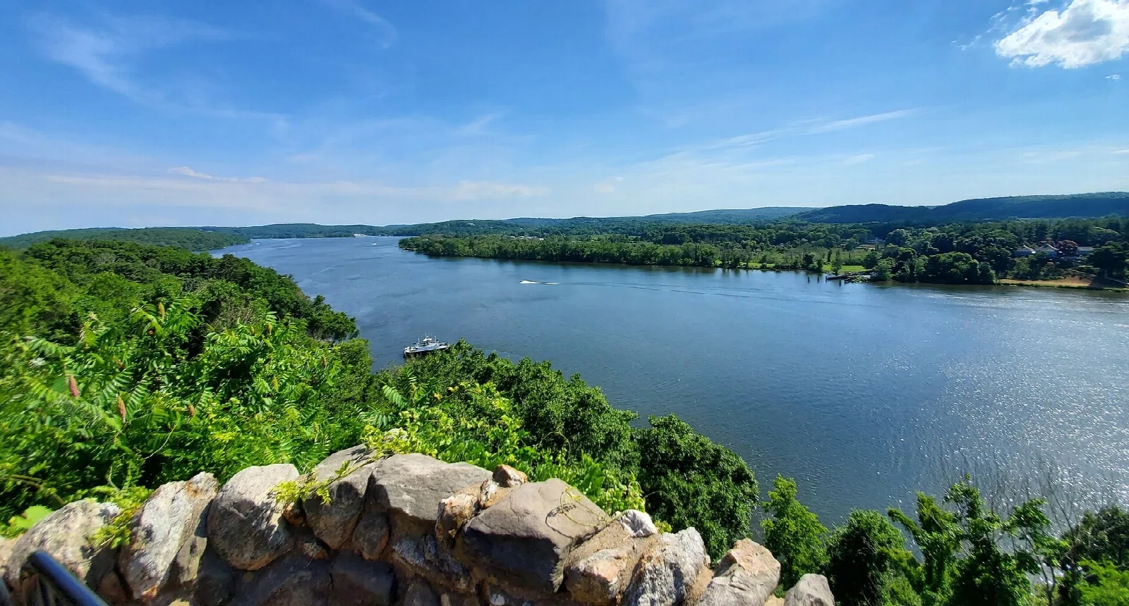 Wide river seen from a stone wall with hills beyond