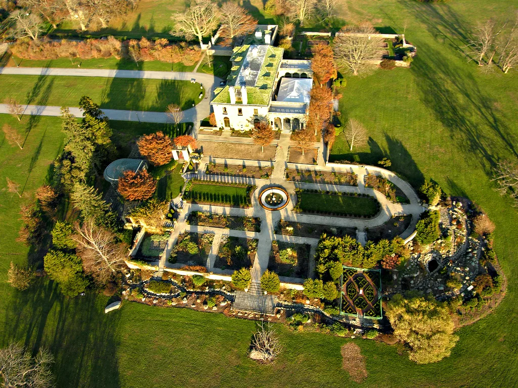 Aerial view of a mansion with formal gardens and lawns