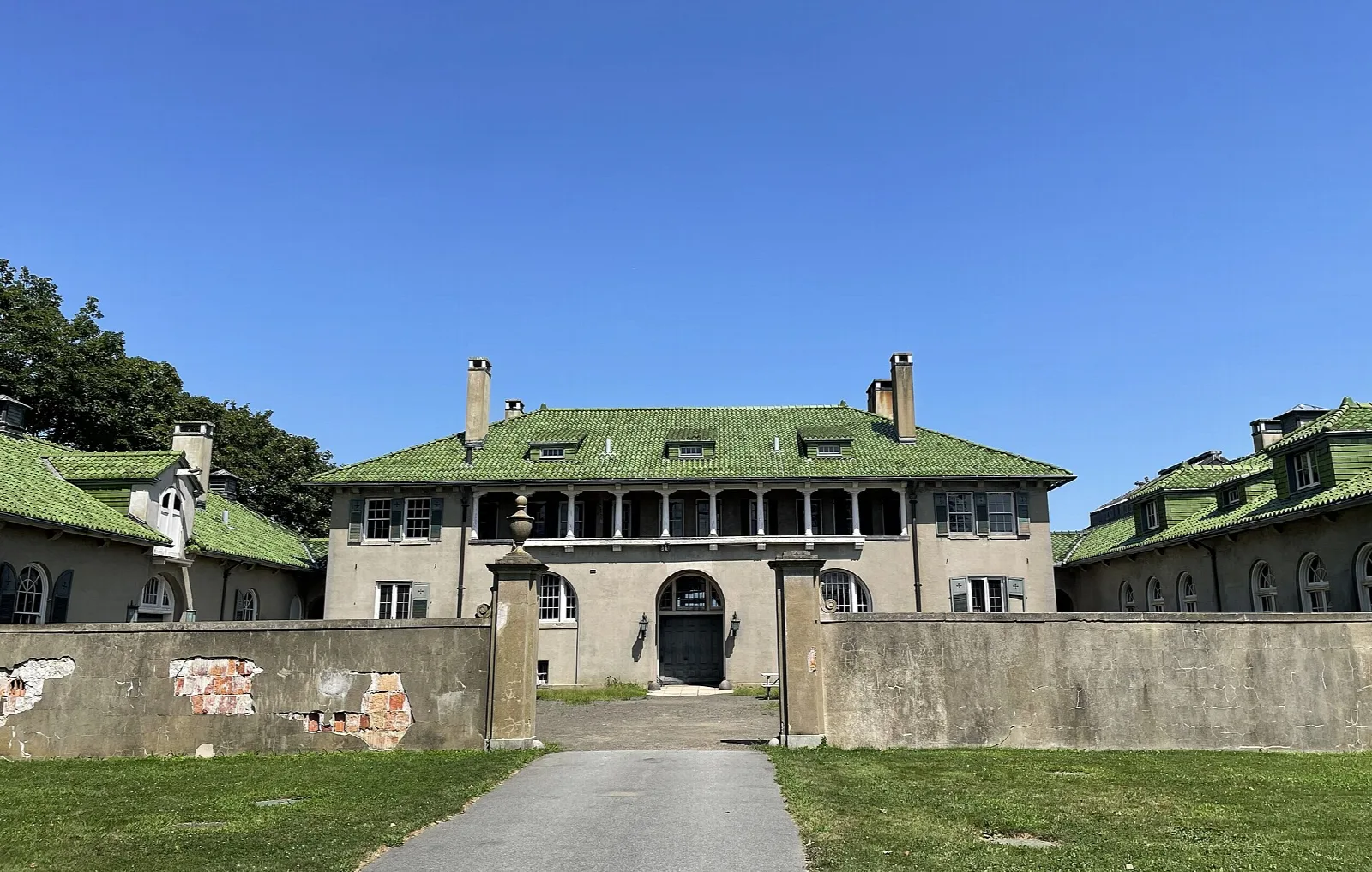 Courtyard entrance of a green-roofed mansion