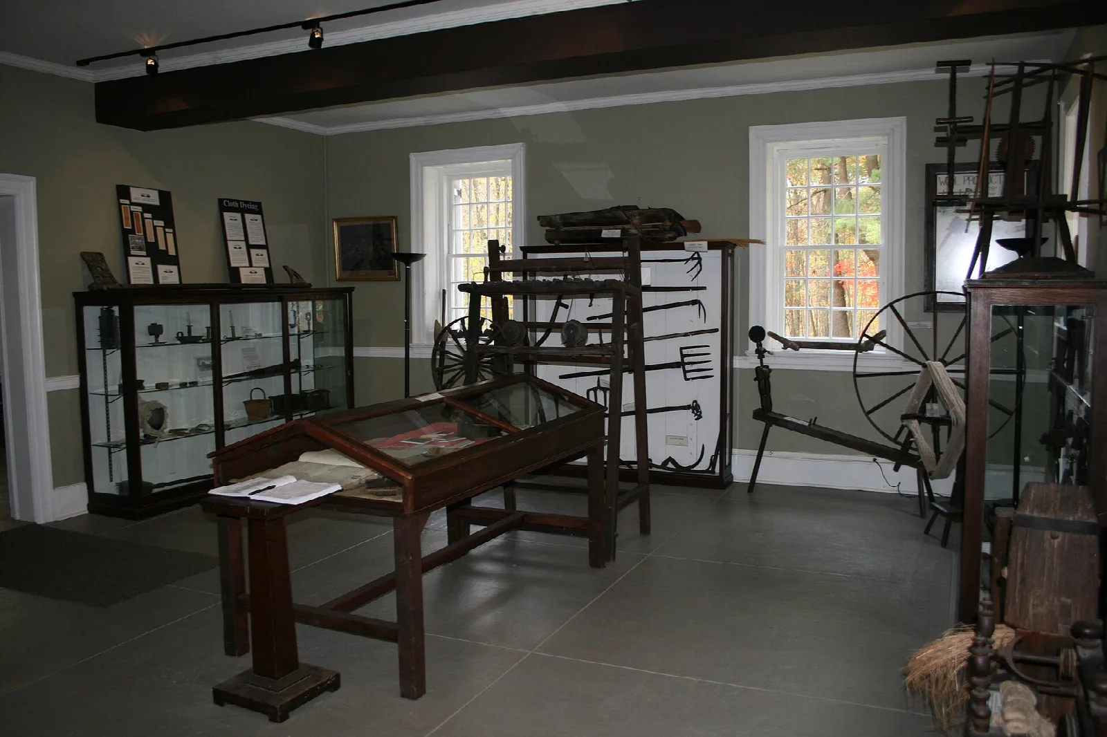 Museum room with old tools and a spinning wheel