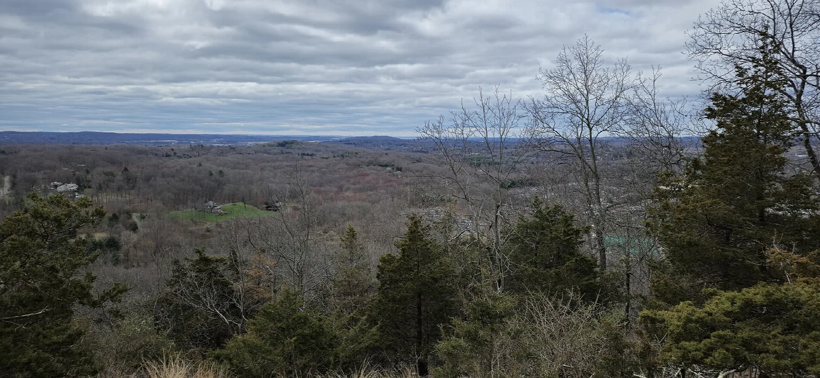 Bare hills seen from an overlook under cloudy sky