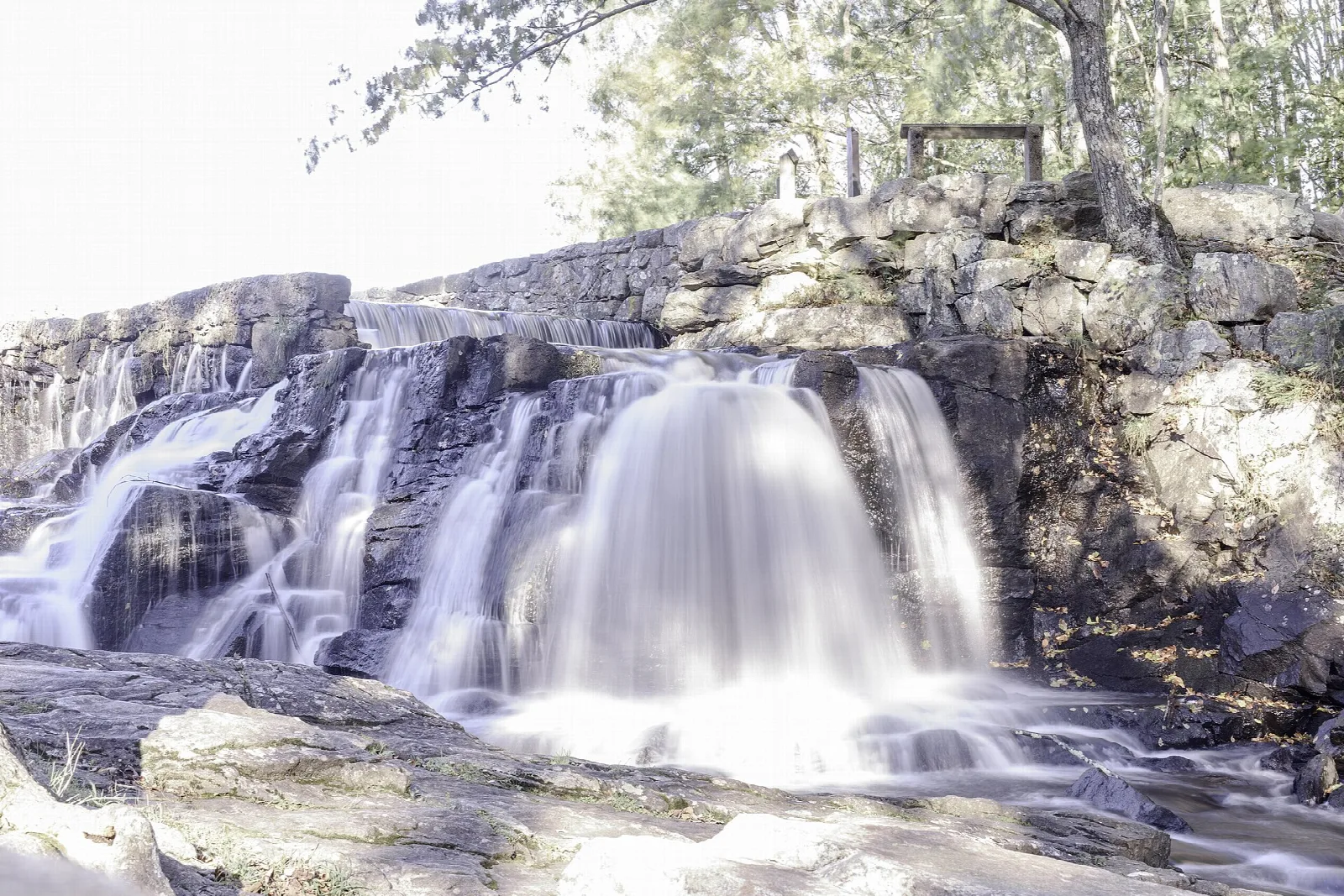 Long-exposure waterfall over dark rock