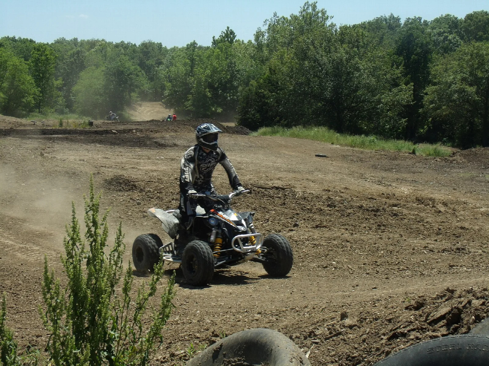 Rider on a quad ATV turning on a dirt track