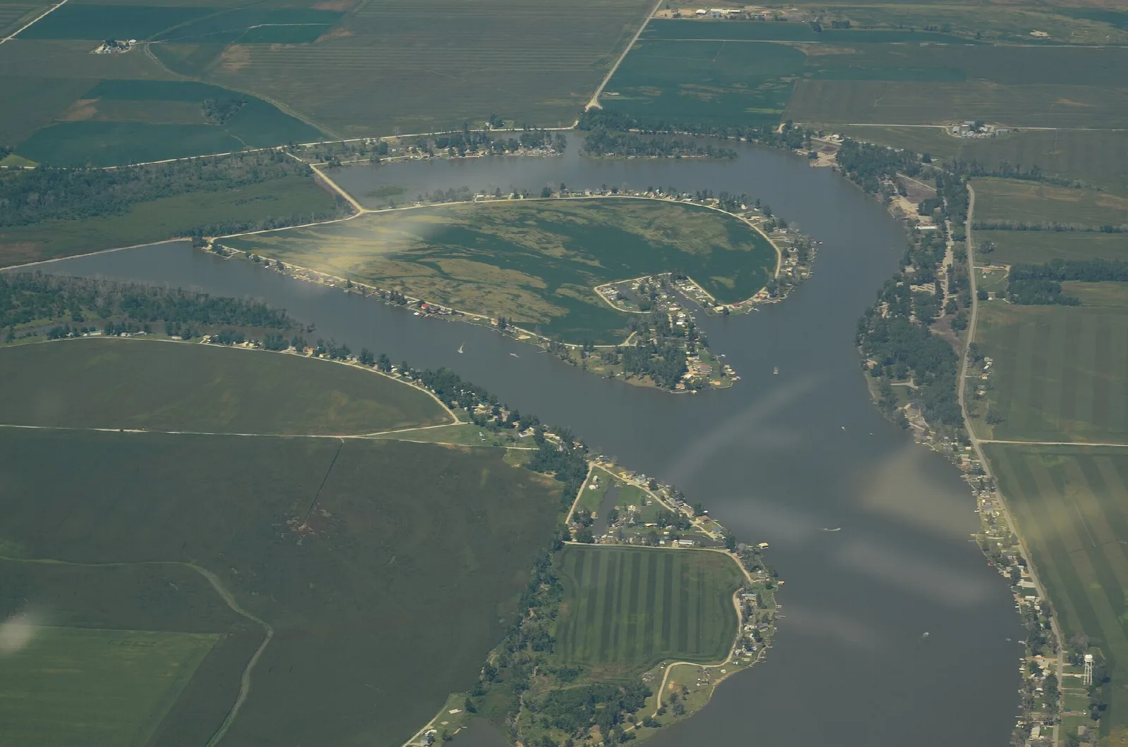 Aerial view of a curving oxbow lake surrounded by farm fields
