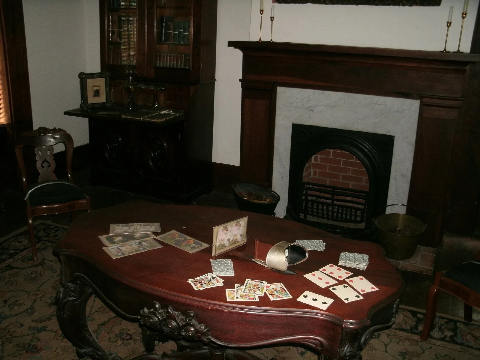 Parlor with a fireplace and a table set with playing cards