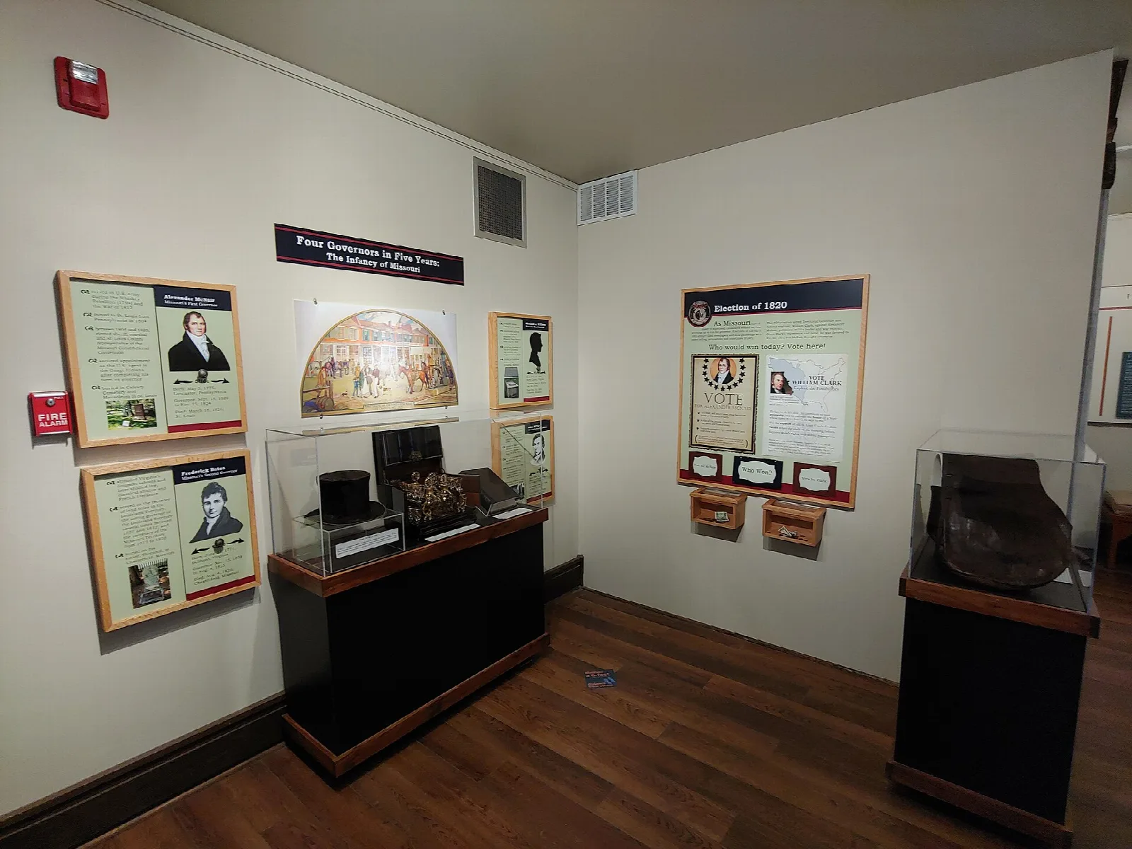 Museum room with wall displays and glass cases
