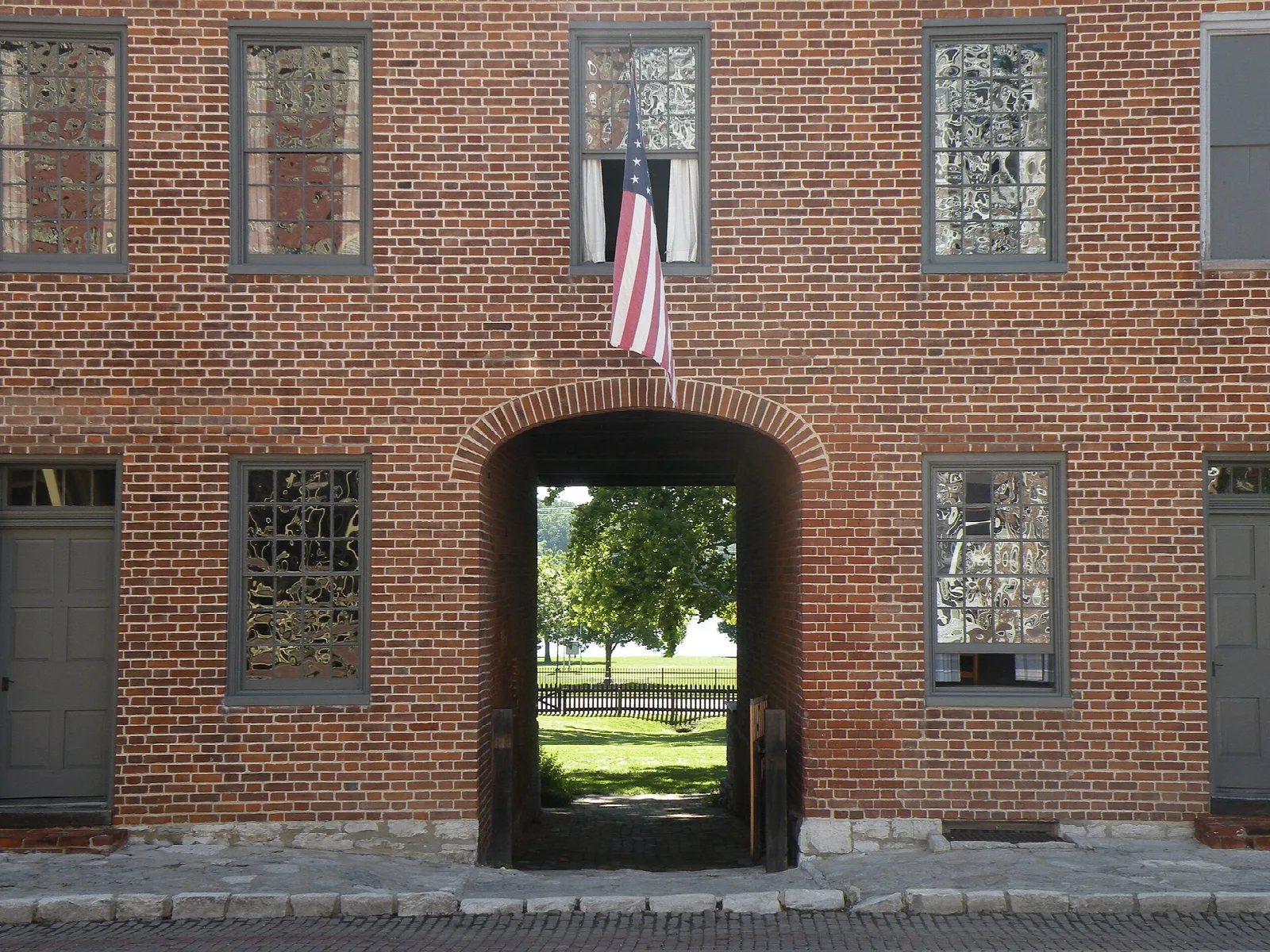 Brick building with an arched passage and an American flag