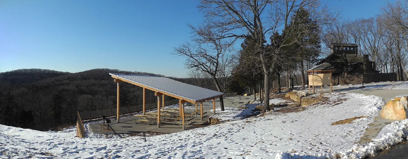 Picnic pavilion and a house on a snowy hilltop overlook