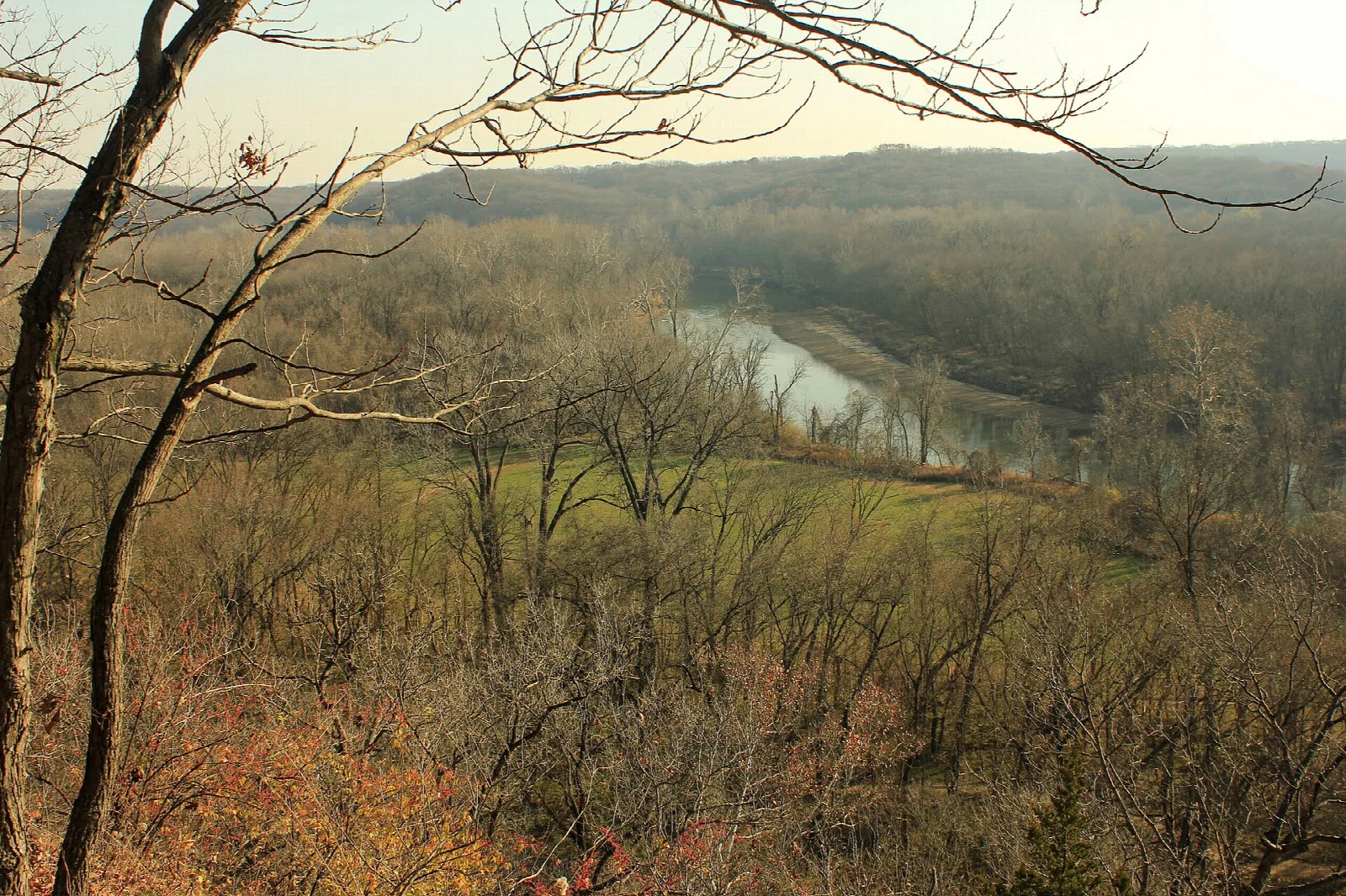 River, meadow and forest seen from a hilltop viewpoint